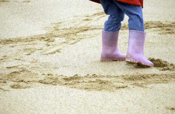 child's welly boots on beach