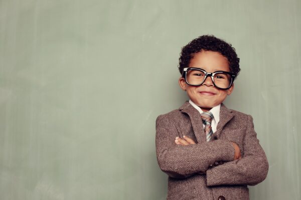 A young boy and knowledge whiz is ready to teach the class. Just add smart copy for the perfect concept.
